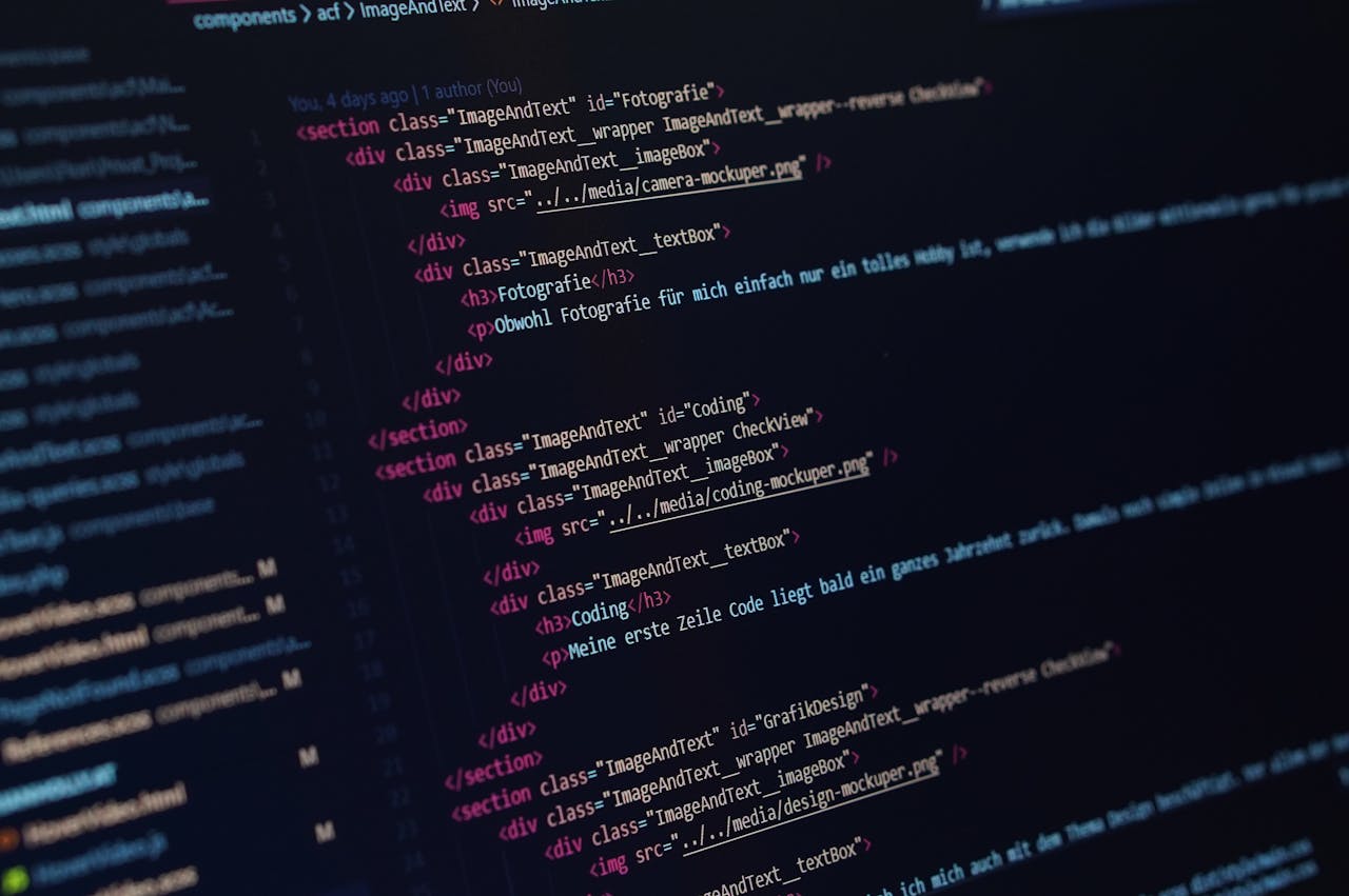 services-02 Close-up view of HTML code displayed on a dark screen, showcasing coding concepts.